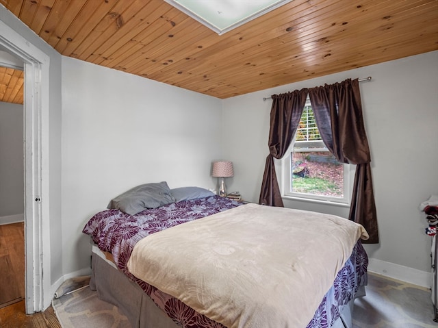 bedroom with wood ceiling and hardwood / wood-style flooring