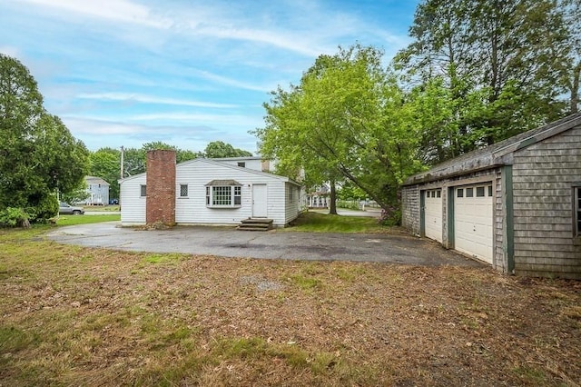 171 Hobart St, Danvers, MA 01923 - rear view of property with entry steps, an outdoor structure, a yard, and a garage