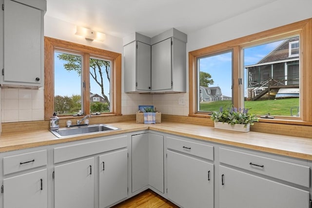 kitchen featuring decorative backsplash and a sink