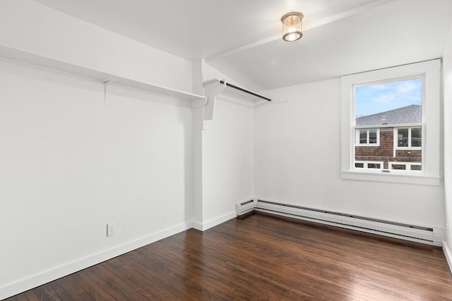 walk in closet with wood finished floors and a baseboard radiator