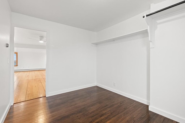 empty room with baseboards, baseboard heating, ceiling fan, and hardwood / wood-style flooring