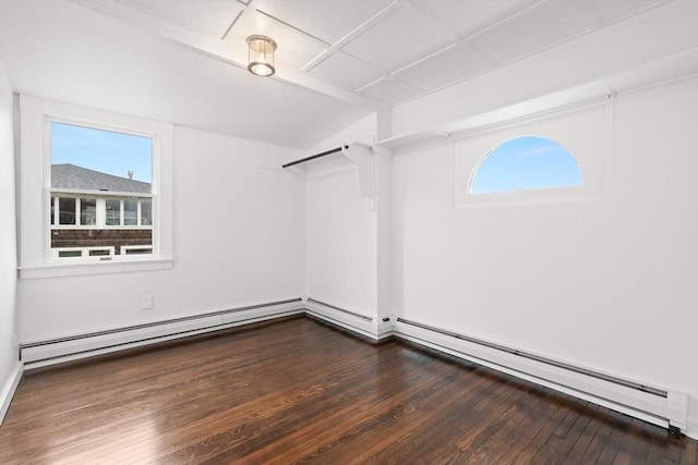 spacious closet with wood finished floors and a baseboard radiator
