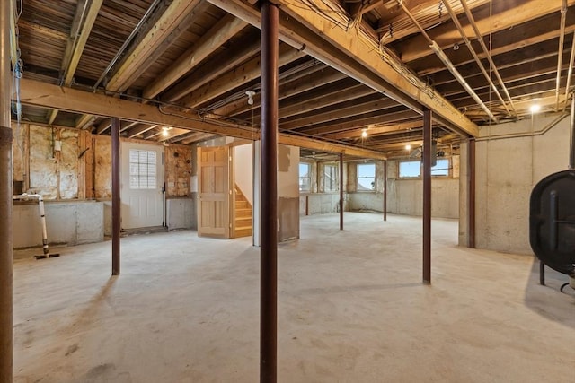 below grade area with heating fuel, a wealth of natural light, and stairs