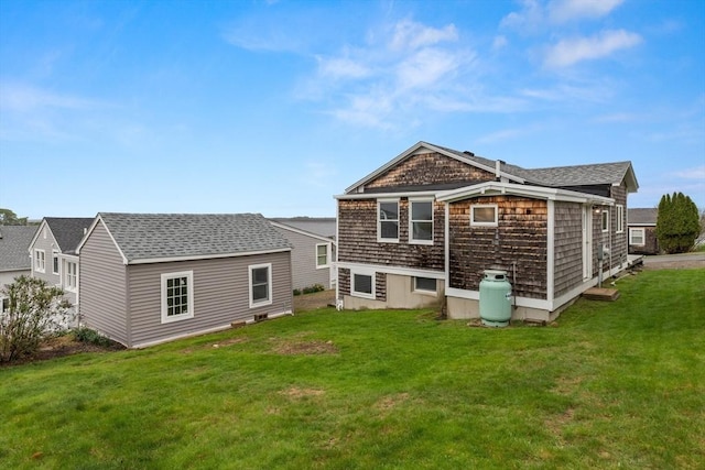 rear view of property featuring a lawn