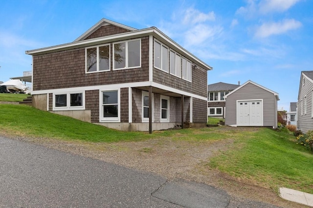 view of front facade featuring a storage shed, an outbuilding, and a front yard
