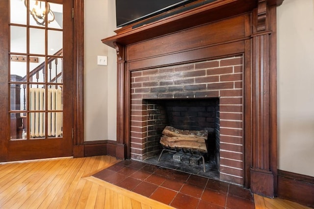 room details with a brick fireplace and wood finished floors