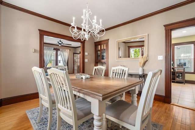 dining space with baseboards, light wood-style floors, and a wealth of natural light