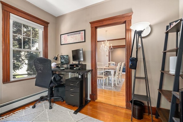 office featuring wood finished floors, a notable chandelier, and baseboard heating