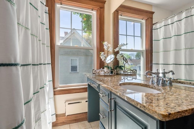 bathroom with a shower with curtain, tile patterned flooring, and vanity