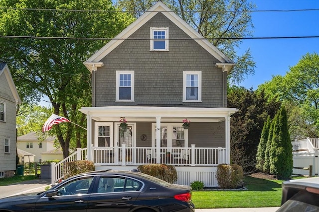 american foursquare style home featuring covered porch
