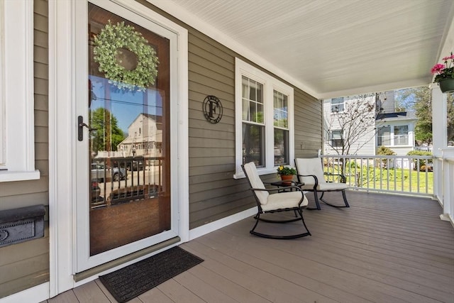 wooden terrace featuring covered porch
