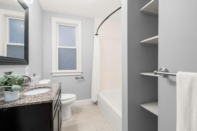 bathroom with shower / bath combo, vanity, toilet, baseboards, and wood finished floors