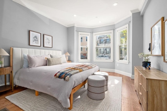 bedroom featuring recessed lighting, baseboards, crown molding, and light wood finished floors