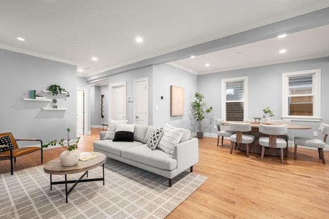 living room with recessed lighting, crown molding, and light wood finished floors