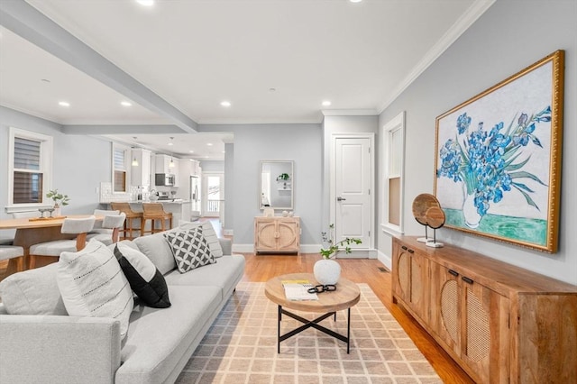 living room featuring baseboards, ornamental molding, recessed lighting, and light wood-style flooring