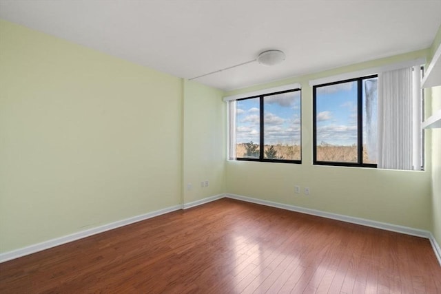 spare room with hardwood / wood-style floors