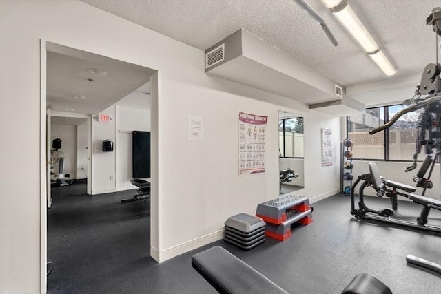 workout room with a textured ceiling