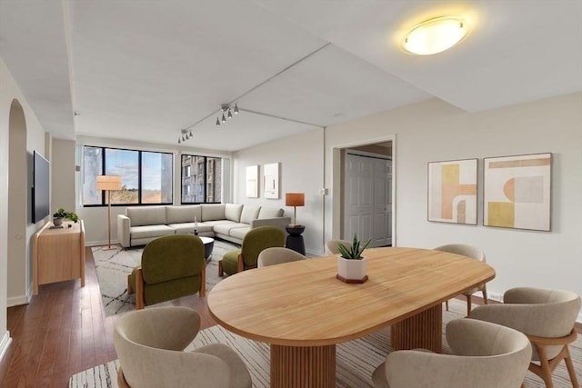 dining room featuring hardwood / wood-style flooring and rail lighting