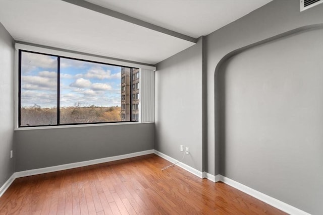 spare room with hardwood / wood-style floors