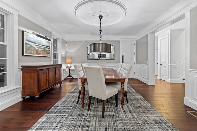 dining space featuring crown molding and dark hardwood / wood-style floors