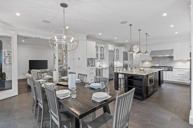 dining space featuring an inviting chandelier and dark tile flooring