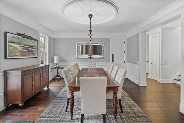 dining room with crown molding and dark hardwood / wood-style floors