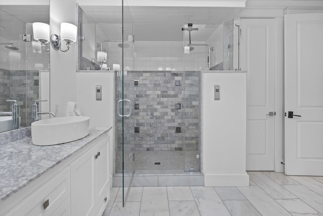 bathroom featuring tile flooring, a shower with shower door, and vanity