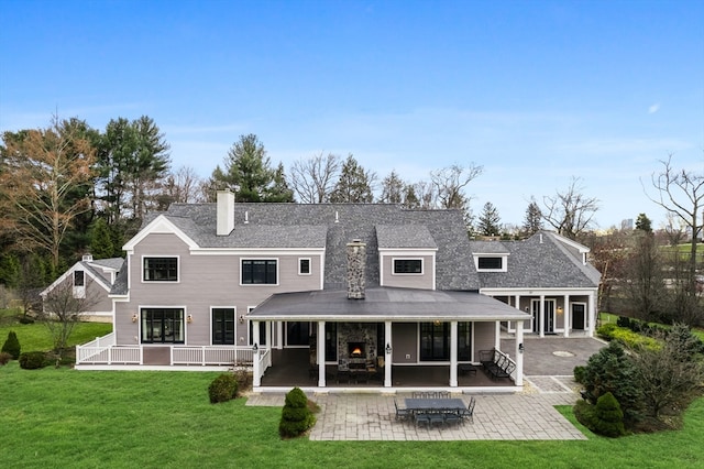 back of house with a patio and a yard