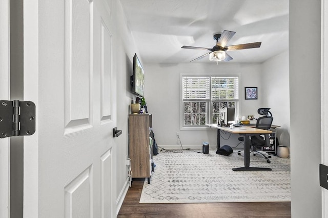 office space featuring dark wood-type flooring and ceiling fan