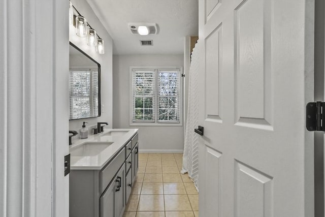 bathroom featuring tile patterned flooring and vanity