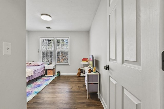 bedroom with dark hardwood / wood-style floors