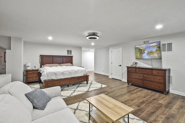 bedroom with dark hardwood / wood-style flooring