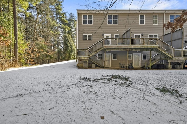 rear view of house featuring a wooden deck