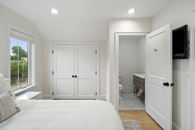 7 Newman St, Cambridge, MA 02140 - bedroom featuring light wood finished floors, ensuite bathroom, recessed lighting, lofted ceiling, and a closet