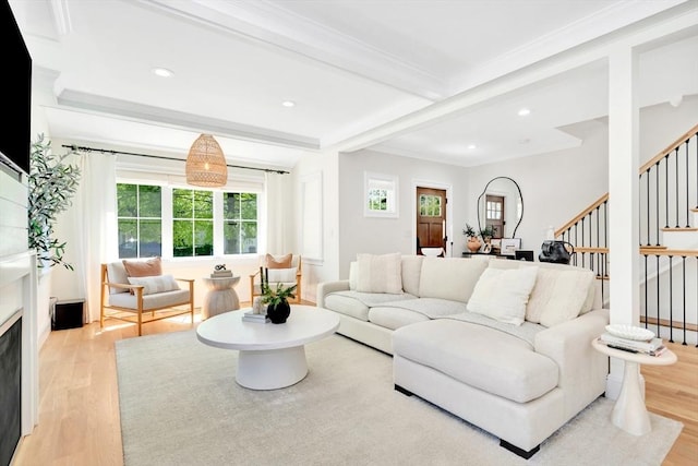 7 Newman St, Cambridge, MA 02140 - living room featuring stairway, light wood-style flooring, a fireplace, recessed lighting, and crown molding