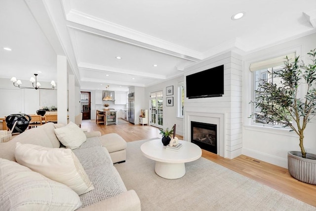 7 Newman St, Cambridge, MA 02140 - living area featuring light wood-style floors, a chandelier, a fireplace, recessed lighting, and beamed ceiling