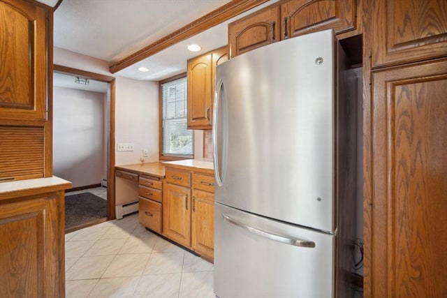 kitchen featuring stainless steel fridge, a baseboard radiator, and light tile patterned flooring