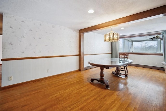 misc room with a notable chandelier, a baseboard radiator, light hardwood / wood-style floors, and beamed ceiling