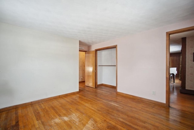 unfurnished room with hardwood / wood-style floors