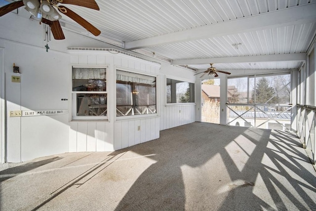 unfurnished sunroom featuring beam ceiling and ceiling fan