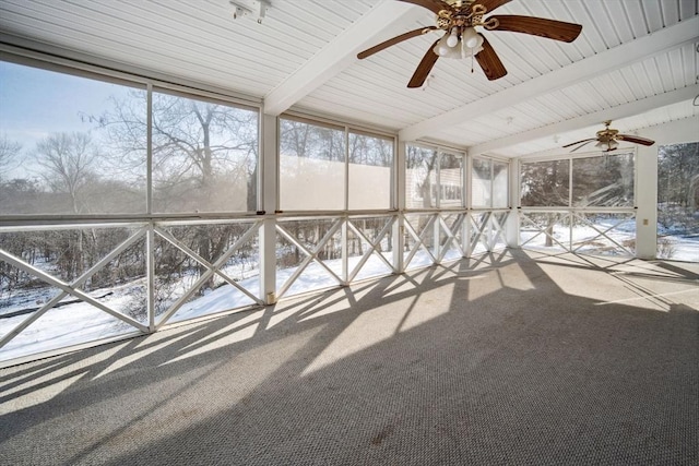 unfurnished sunroom featuring lofted ceiling with beams