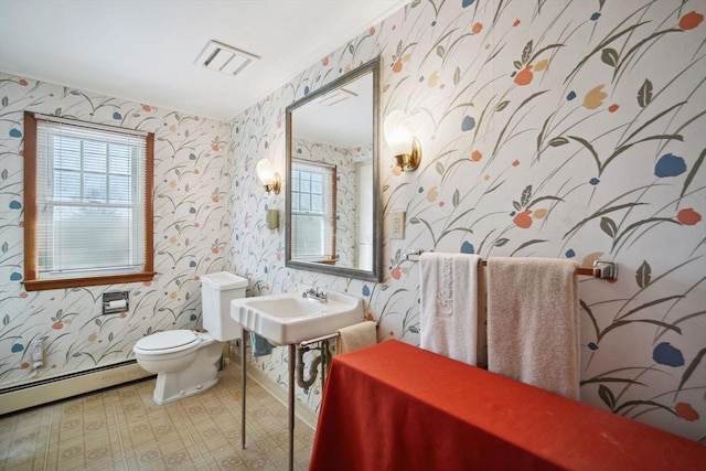 bathroom featuring a baseboard radiator, toilet, and sink