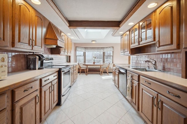 kitchen with premium range hood, a skylight, decorative backsplash, stainless steel appliances, and beam ceiling