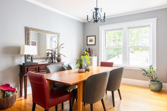 202 Fuller Unit 6, Brookline, MA 02446 - dining area featuring a chandelier, light wood-type flooring, crown molding, and baseboards