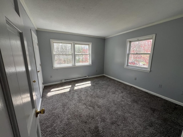 spare room featuring a textured ceiling, baseboards, carpet, baseboard heating, and crown molding