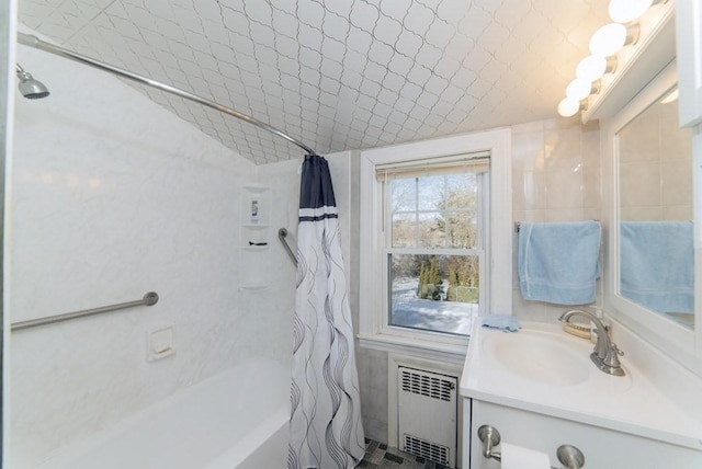 full bath featuring vanity, radiator heating unit, and shower / bath combo with shower curtain