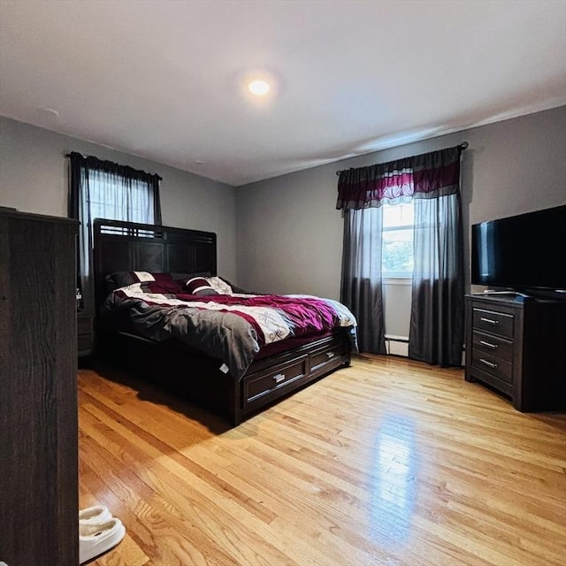 bedroom featuring a baseboard radiator and light wood-type flooring