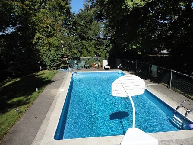 view of swimming pool with a fenced in pool and fence