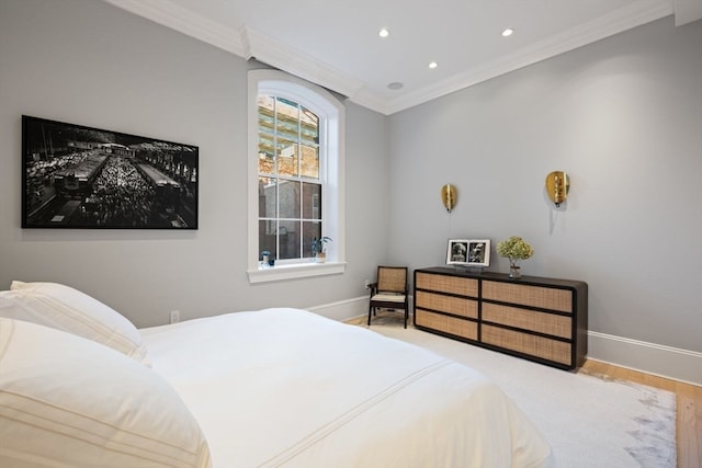 bedroom featuring light wood-type flooring and crown molding