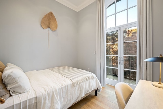 bedroom featuring light wood-type flooring and crown molding